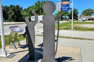 Shadow sculpture of gas attendant and pump Shadow sculpture of gas attendant and pump