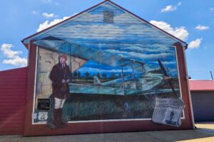 Amelia Earhart mural - Sept 4, 1928 - Amelia Earhart coming to City! First woman to fly across Atlantic due here today but reported down. Miss Earhart was forced down near Cuba, MO about 75 miles SW of St. Louis, according to advices received at Hatbox field this afternoon. The extent of damage to her plane, if any, was not given. If it was not damaged greatly, it is expected she will continue her journey and land at Hatbox field tomorrow. Amelia Earhart mural - Sept 4, 1928 - Amelia Earhart coming to City! First woman to fly across Atlantic due here today but reported down. Miss Earhart was forced down near Cuba, MO about 75 miles SW of St. Louis, according to advices received at Hatbox field this afternoon. The extent of damage to her plane, if any, was not given. If it was not damaged greatly, it is expected she will continue her journey and land at Hatbox field tomorrow.