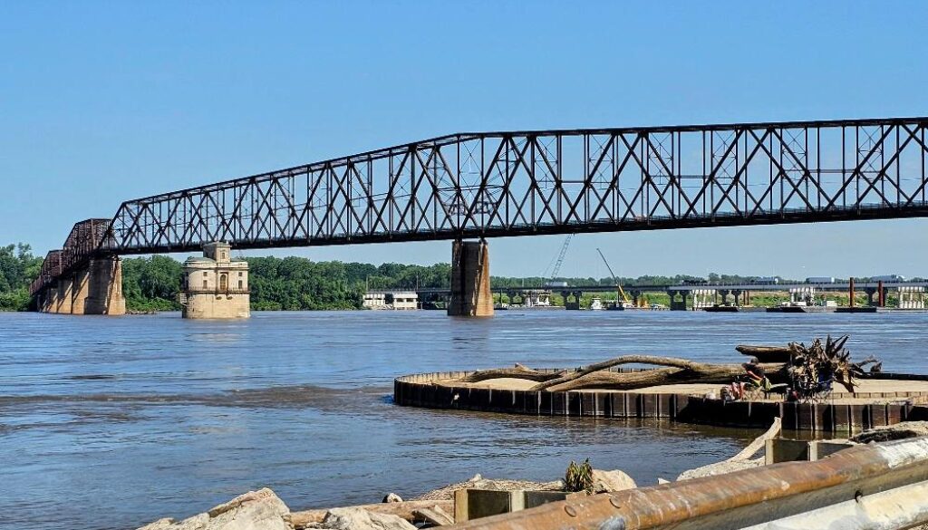 The log on the fishing platform dwarfs the people