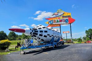 The famous Uranus sign with a giant rocket out front
