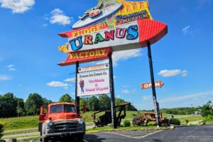 The other side of the Uranus sign has a vintage truck and a sign for HoMade Ice Cream