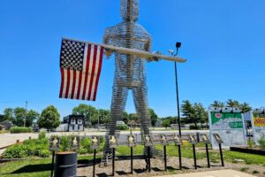 A giant sculpture holding a flag A giant sculpture holding a flag
