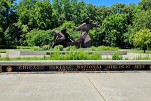 Native American with European Explorers portage their canoe Native American with European Explorers portage their canoe
