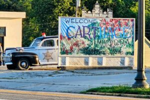 Po-po sitting behind the Welcome to Carthage sign Po-po sitting behind the Welcome to Carthage sign