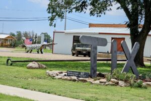 Worlds Largest Branding Iron & "Hank" the Ankylosaurus in background Worlds Largest Branding Iron & "Hank" the Ankylosaurus in background
