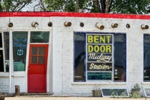 The red front door is "bent" at its waist The red front door is "bent" at its waist